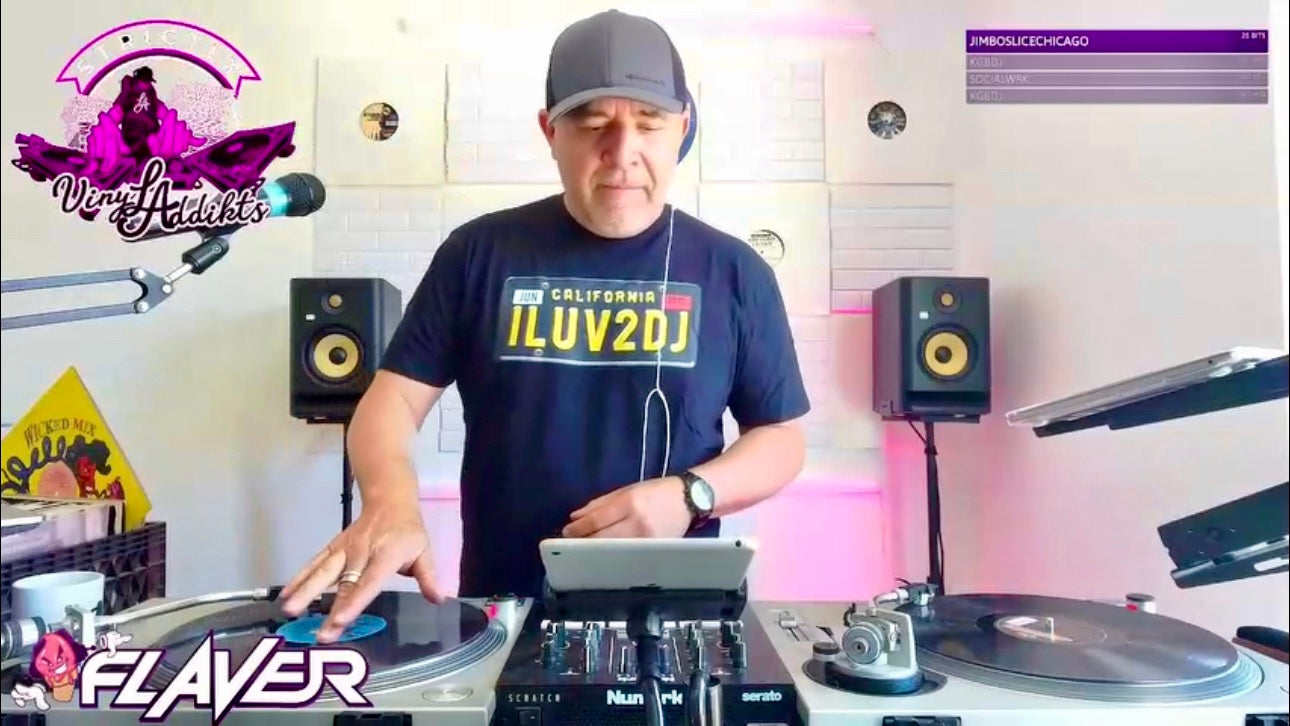 DJ performing at a turntable with 'Flaver' branding in the background
