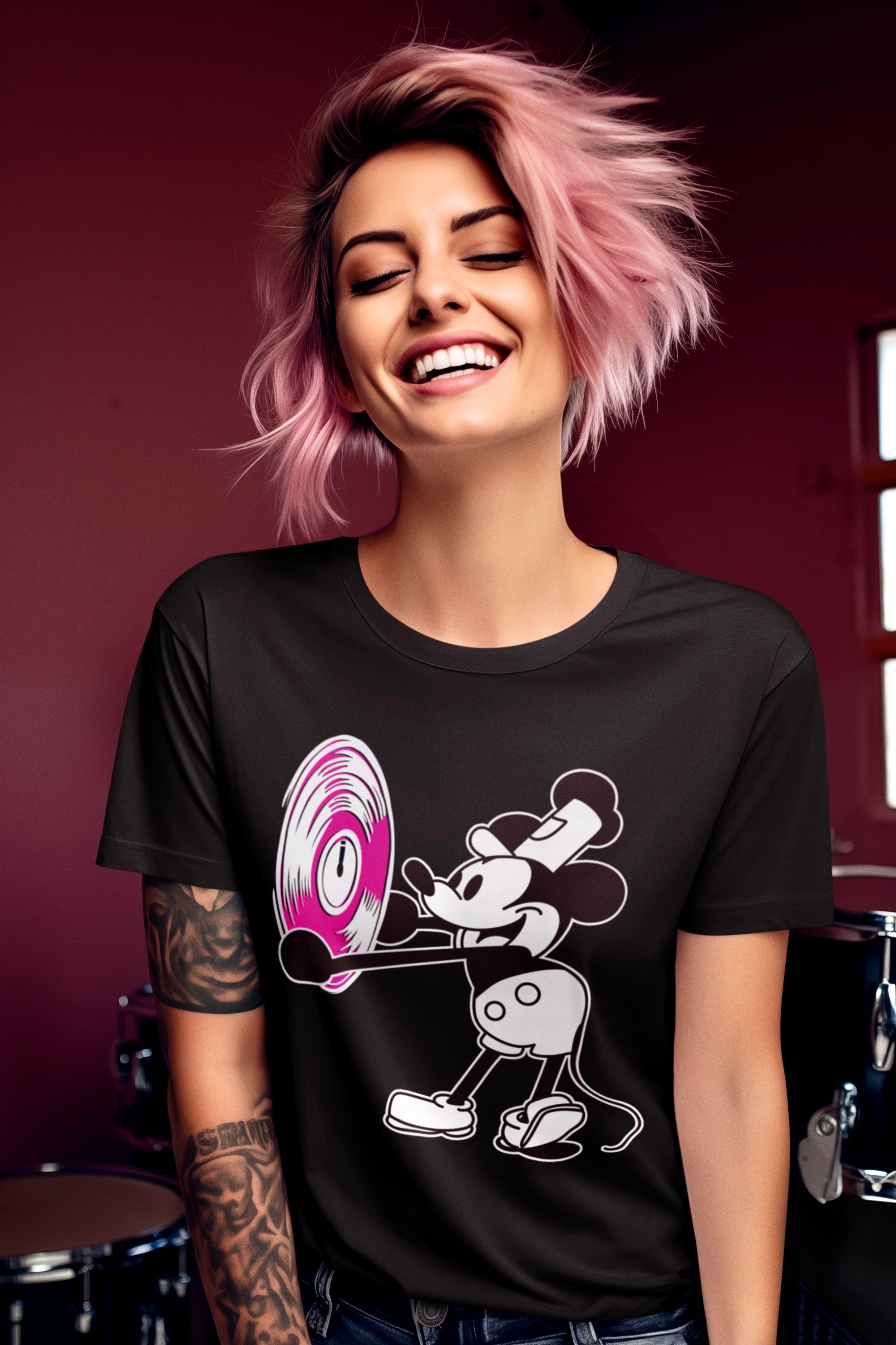 Woman wearing a black t-shirt with a graphic design, smiling against a red background.